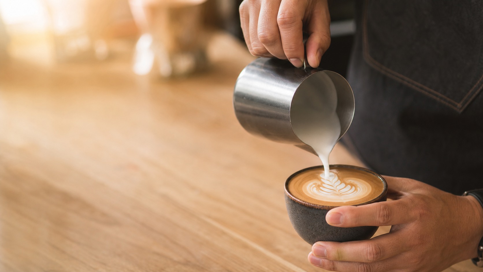 Latte with leaf art in a ceramic cup
